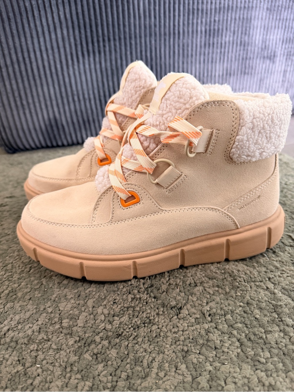 Sorel Explorer Cream Sherpa-Lined Ankle Boots with Peach Accents.